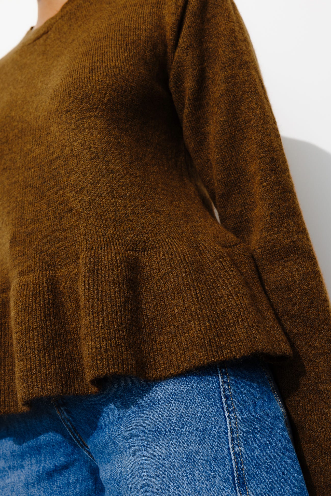Jumper with wavy peplum waist