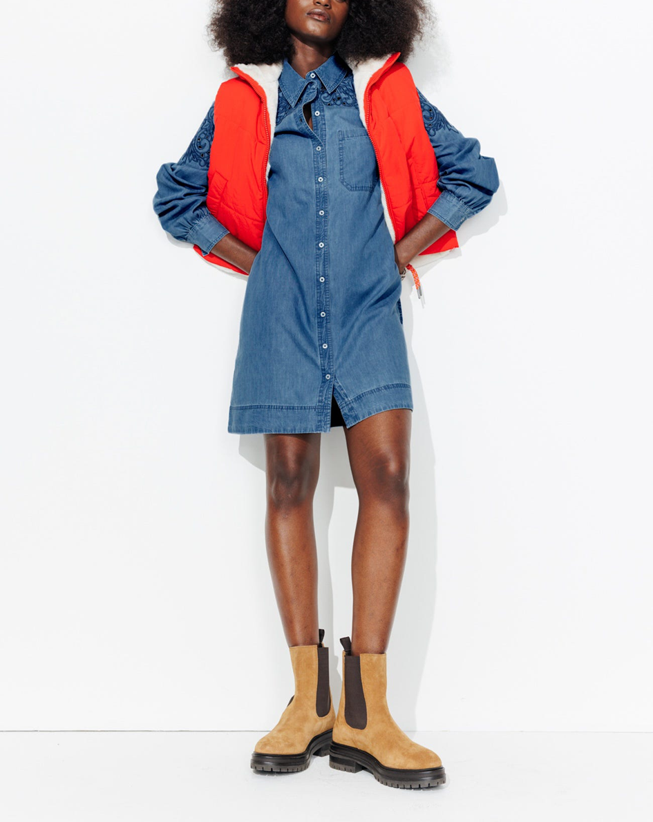 mannequin portant une robe-chemise en jean bordé avec une doudoune au dessus